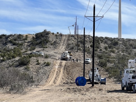 KTX line crews and utility trucks working across rugged West Texas terrain